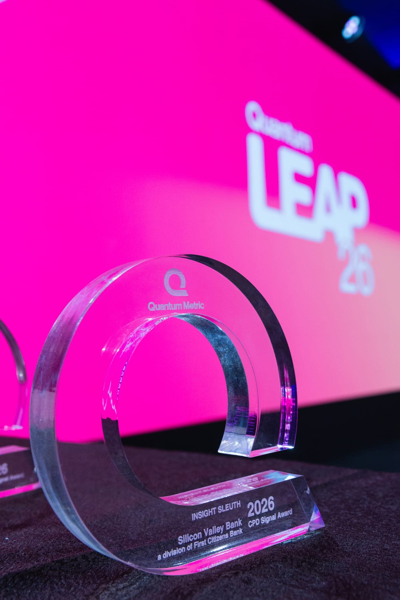 CPD Signal Awards trophy, a clear acrylic ring, in front of a pink LEAP 26 screen